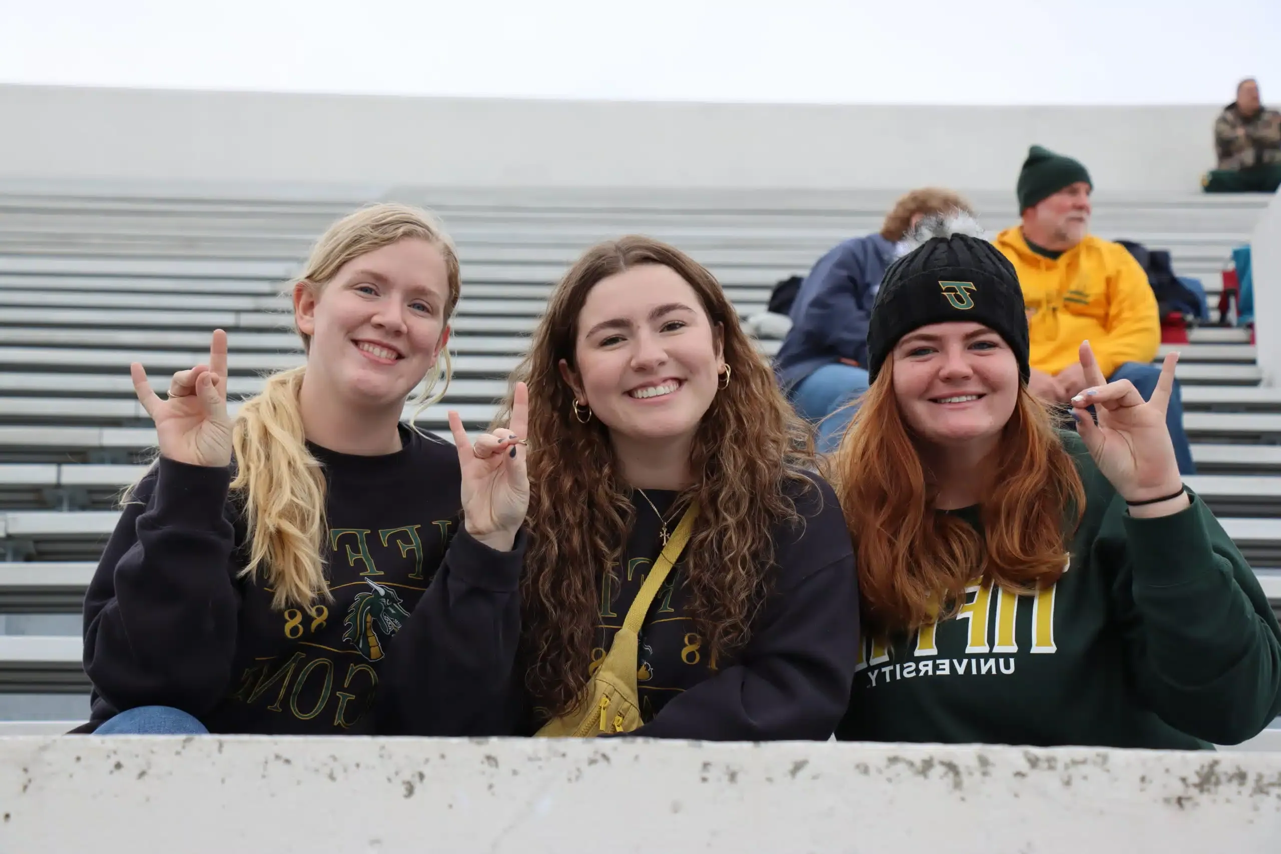 smiling alumni at football game